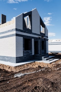 Under Construction Modern Brick House with Blue Sky photo