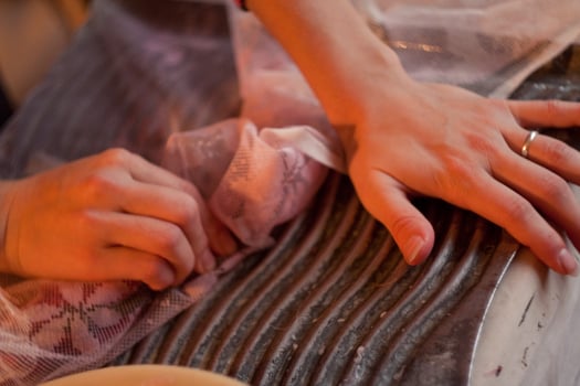 A person is cutting up a piece of meat photo