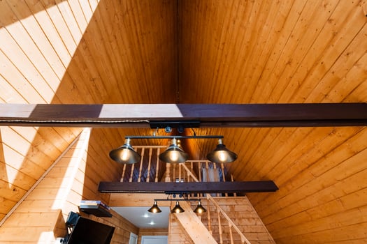 A wooden staircase with a light fixture above it photo