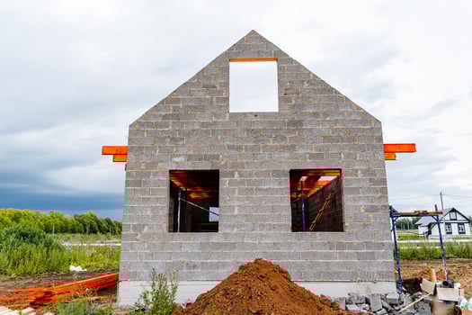 A house under construction with a dirt pile photo