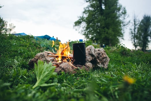 A campfire is sitting on a grassy field photo
