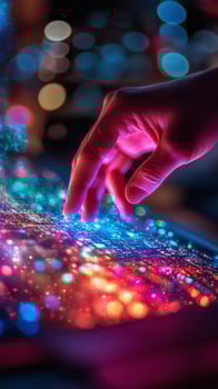 A person touching a tablet with colorful lights photo