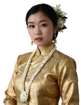 A woman in a gold dress and necklace photo