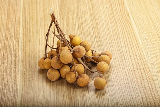 A bunch of fruit on a wooden table photo