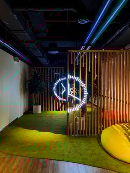 A room with a neon sign on the wall photo