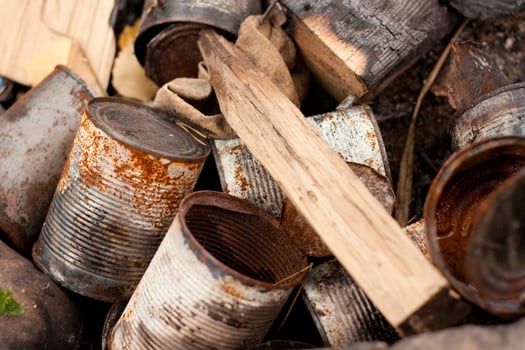 Old rusty cans and wood are piled together photo