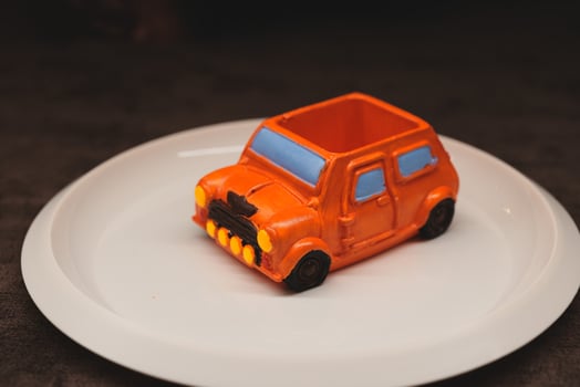 A delightful and colorful presentation of a toy car themed dessert for a joyful celebration photo