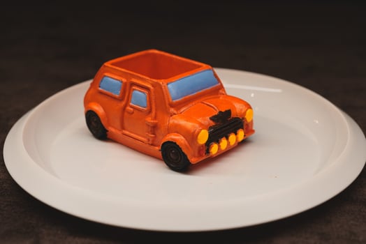 Introducing a Creative Edible Car Dessert a fun and vibrant bright orange colored treat photo