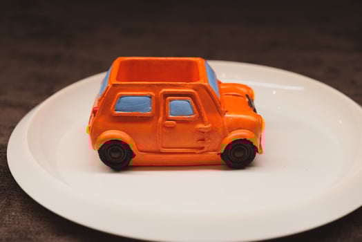 A Brightly Colored Toy Car Displayed on a Vibrant Plate, Perfect for Kids and Parties photo