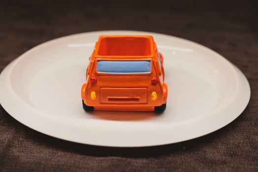 A Colorful Toy Car Placed on a Plate An Engaging and Creative Concept Displaying Playfulness photo