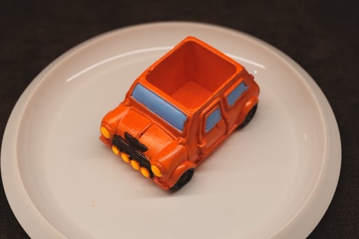 A Bright and Colorful Toy Car Laid Out in an Impressive Plate Setting Ready for Display photo