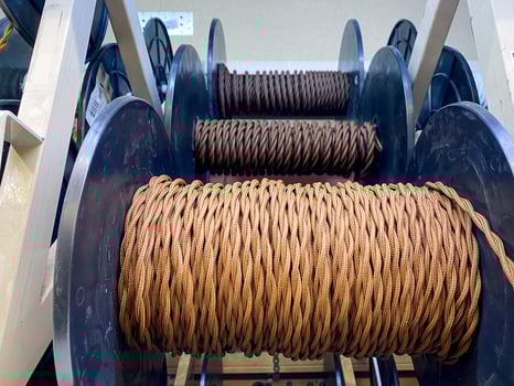 This vibrant and colorful collection of neatly stacked rope spools prominently showcases a diverse variety of types that are designed for numerous applications across various industries photo