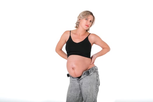pregnant woman with backache holding back photo