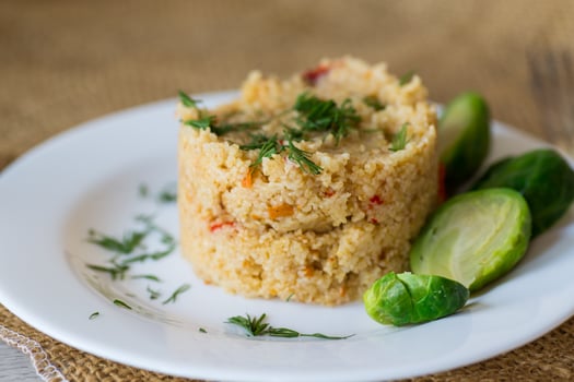 boiled bulgur with vegetables in a plate photo