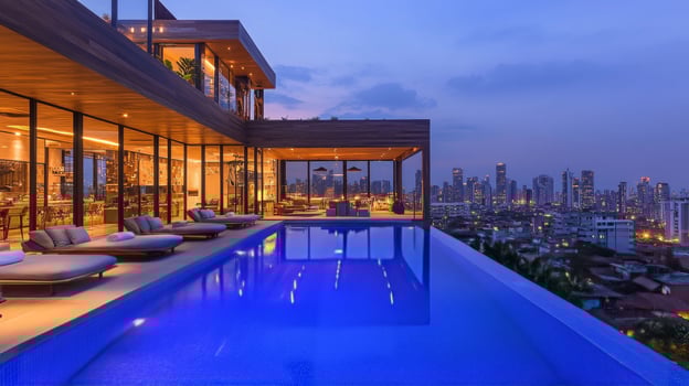 The pool at the top of the building is lit up at night photo