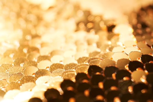 Abstract festive gold background made of sequins. photo