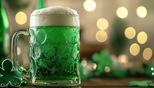 Frothy green beer mug at festive celebration with bokeh lights photo