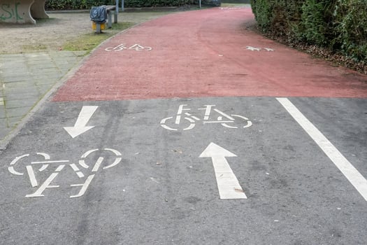Two way cycle path splitting into two one way lanes with opposite directions photo