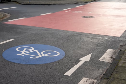 Bicycle lane crossing red bike path at urban intersection photo