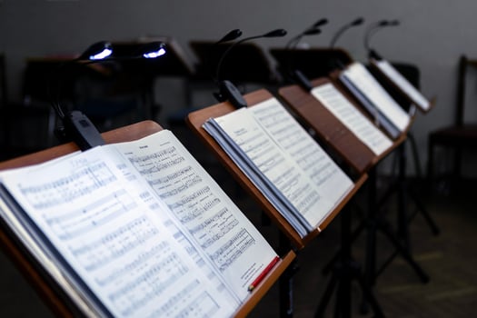 Music stands with musical notes in the rehearsal room, The music stands have lanterns attached to them for lighting. photo