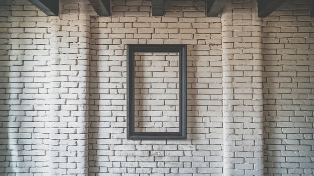 Empty Black Frame on White Brick Wall in Rustic Industrial Interior with Exposed Wooden Beams photo