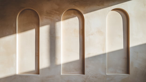 Minimalist Beige Wall with Three Arched Niches and Sunlight Shadows in Modern Interior Design Aesthetic photo
