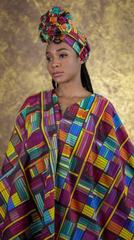 Vibrant African Print Attire Woman Wearing Traditional Headwrap on Gold Textured Background photo