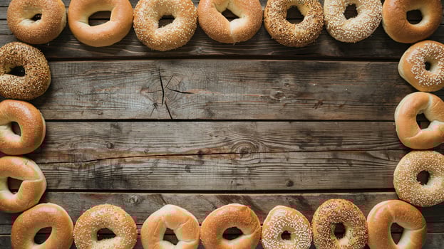 Round Variety of Fresh Bagels Framed on Rustic Wooden Background in Warm Natural Light photo