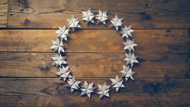 White Origami Star Wreath on Rustic Wooden Table Background for Holiday Decoration Concept photo