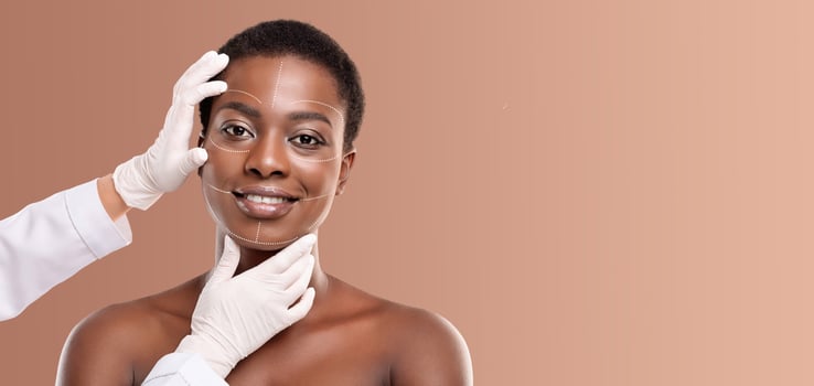African American woman engages in a self-care beauty routine, with a focus on skin treatment. She appears relaxed and content while receiving pampering photo