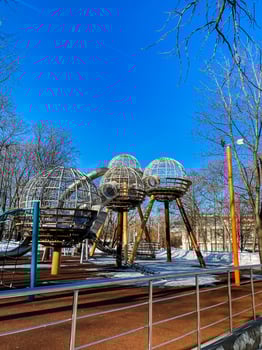 A playground with a large metal structure in the middle photo