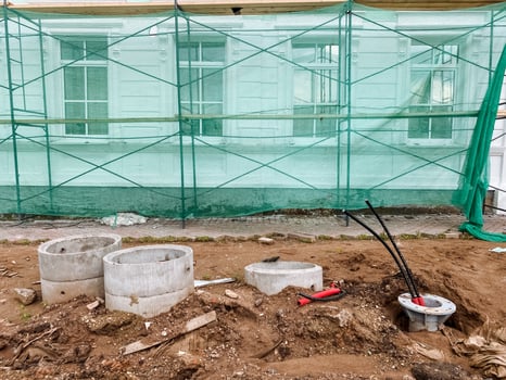 A construction site with a green tarp covering it photo