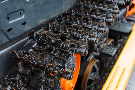A close up of a train track with orange and black wheels photo