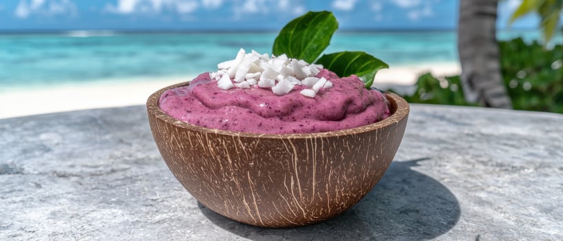 Delicious smoothie bowl with coconut flakes on tropical beach photo
