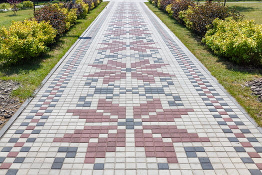 A beautiful path paved with paving slabs in the form of an embroidered Ukrainian ornament. photo