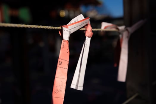 Fortune slips at Kameido Tenjin shrine in Tokyo close up photo