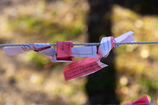 Fortune slips at Kameido Tenjin shrine in Tokyo close up photo