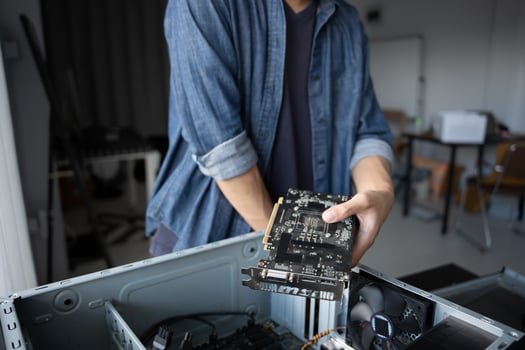 IT Engineer holding a computer motherboard in his hands photo