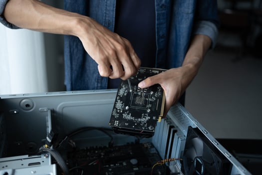 IT Engineer is fixing a motherboard in a computer photo