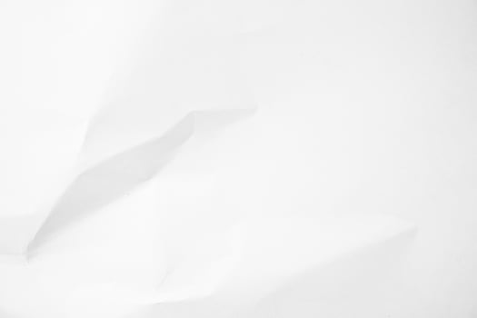white paper crumpled on a white surface photo