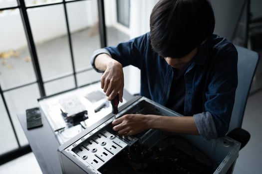 a IT Engineer man working on a computer in a room photo
