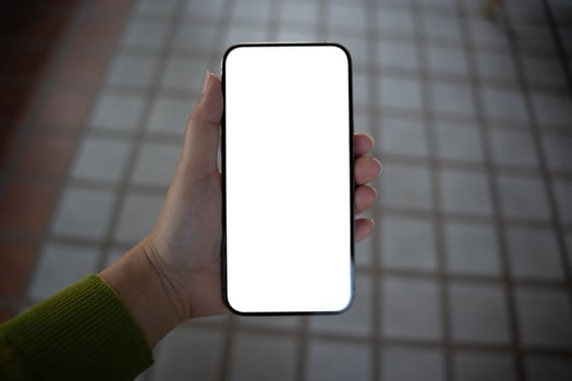 woman hand holding up a blank white phone photo