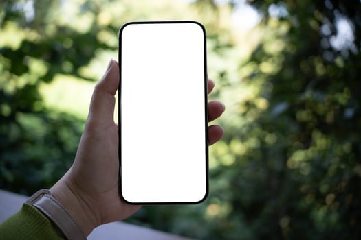 a woman hand holding up a blank white phone screen photo