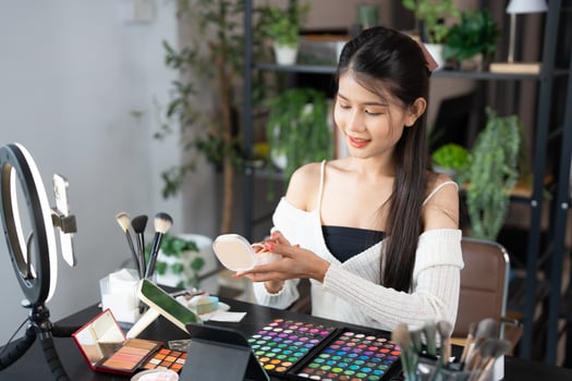 beauty and makeup concept, woman applying makeup in office. photo