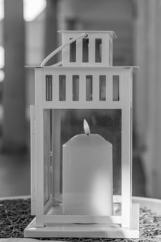 Elegant candle lantern casting warm light in a cozy indoor setting during a relaxing evening photo