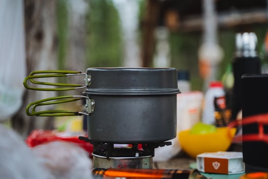 A pot is on a gas stove in the kitchen, ready for cooking photo
