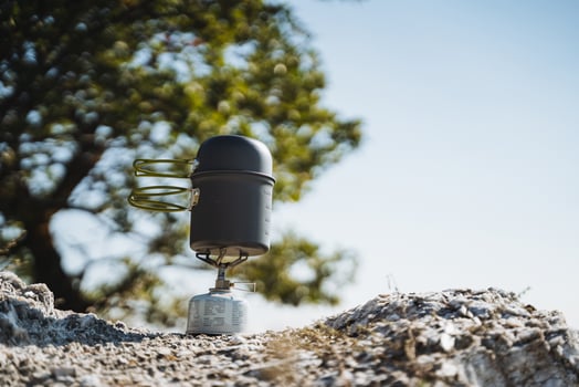 An innovative outdoor surveillance device is installed on rocky terrain, all under a clear sky, perfect for adventure and monitoring activities photo