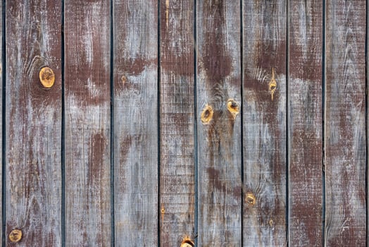 The texture of an old weathered fence with a clear structure of fibers and knots. photo