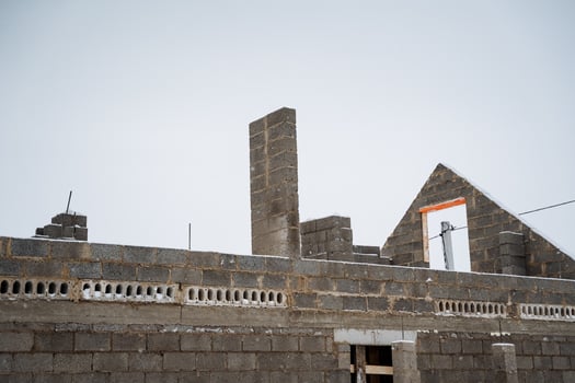 A new building is currently being constructed using bricks along with chimneys as essential features of the architectural design, emphasizing overall aesthetic and functionality photo