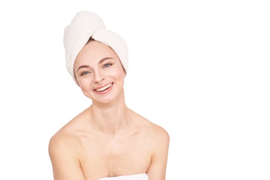 Caucasian female young adult smiling with towel on head against white background. photo